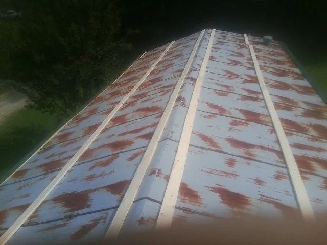 Rusted metal roof panels with new wood purlins before replacement — Storm Damage Roof Repair in Marlton by Roofing Brothers