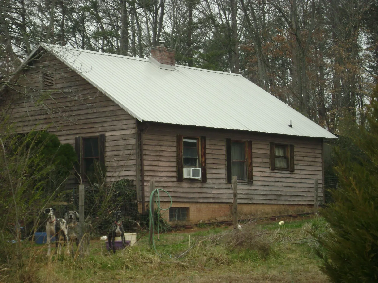 White metal roof on an old wood sided farmhouse, from a Metal Roof Installation job in Marlton